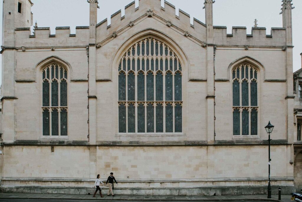 couple passing by the All Souls College in Oxford