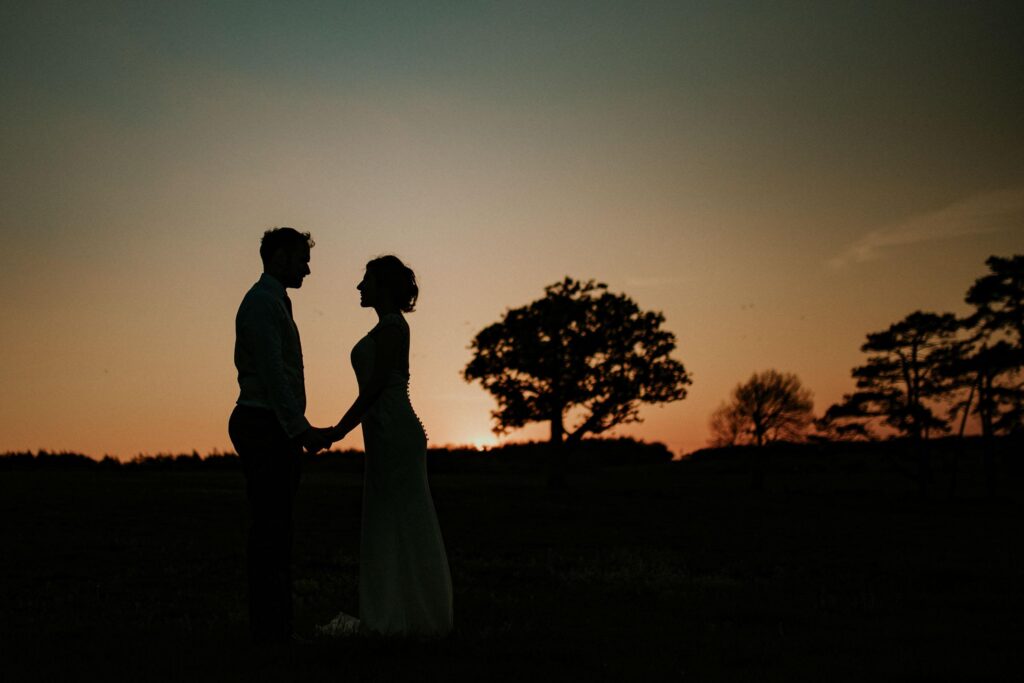 couple watching sunset silhouette