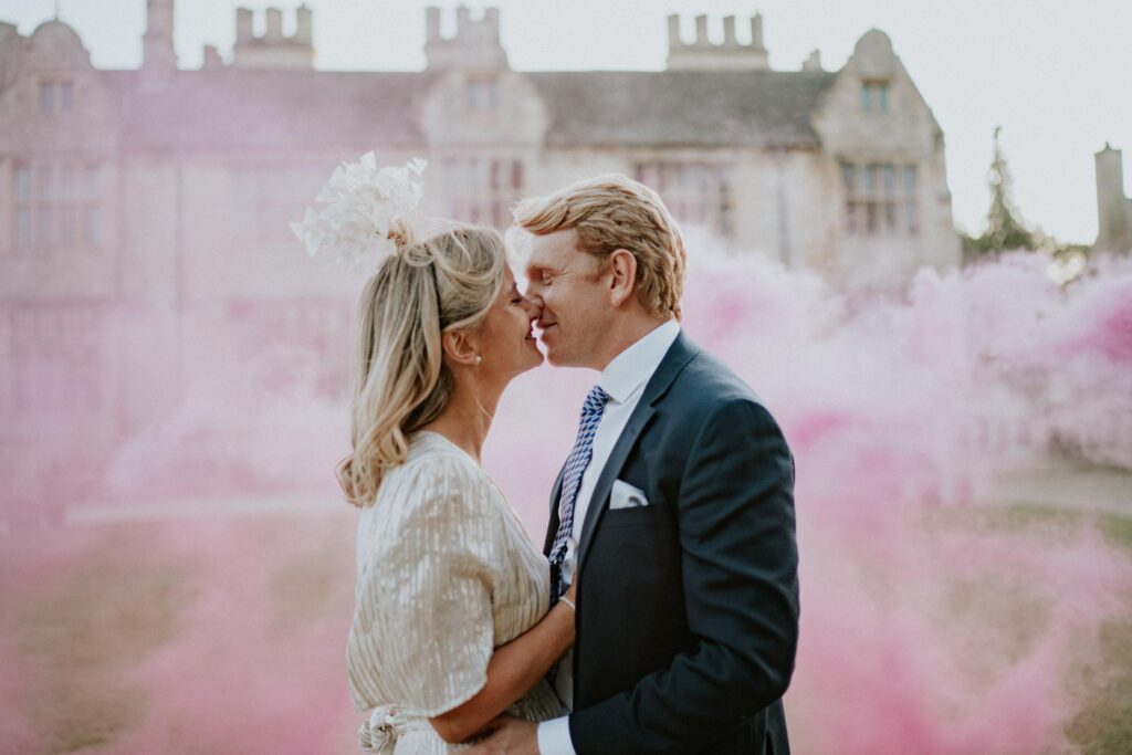 bride and groom kissing on the front of yarnton manor oxfordshire