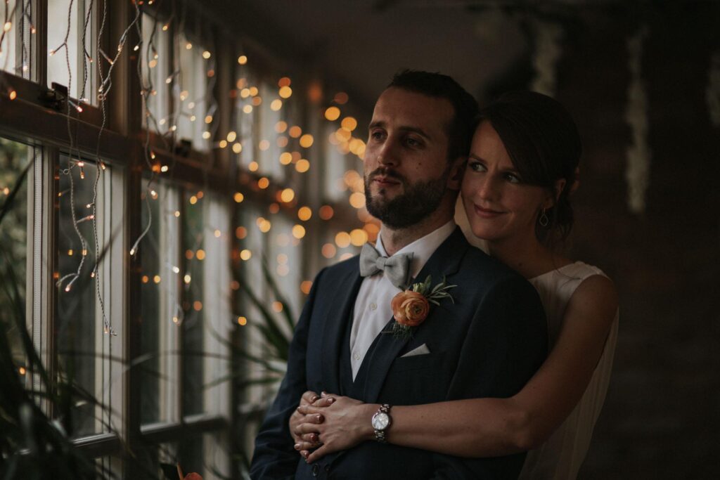 bride and groom cuddling in the crown inn woodstock