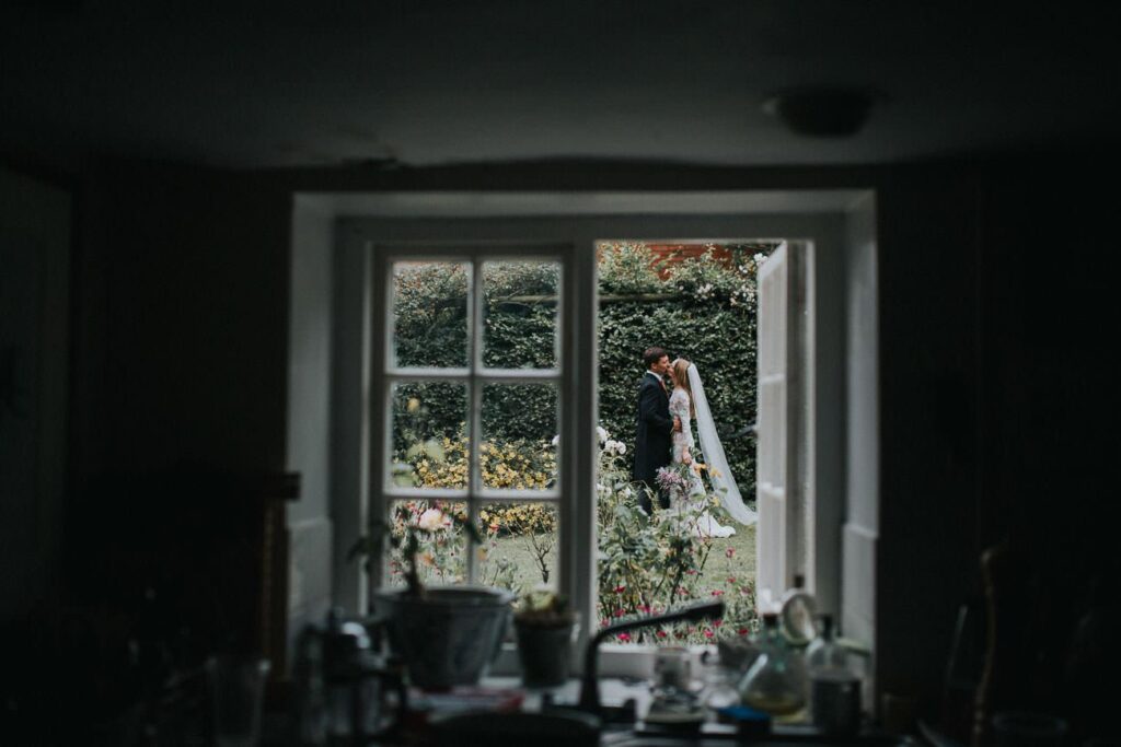 bride and groom kissing in the garden