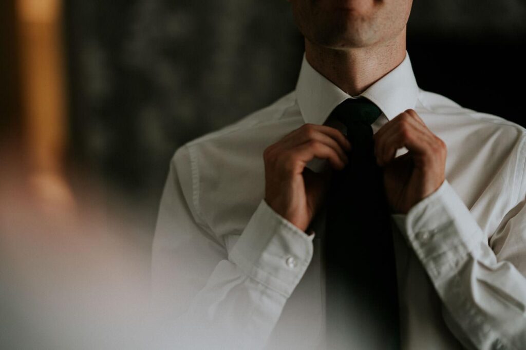 groom folding his tie