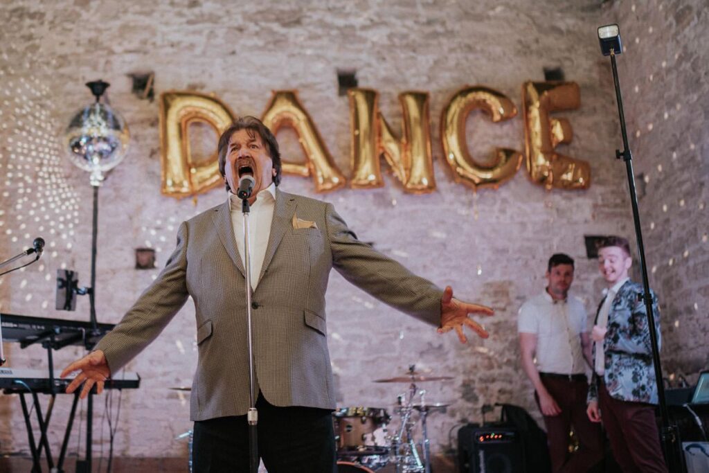 a man is emotionally gesturing while singing