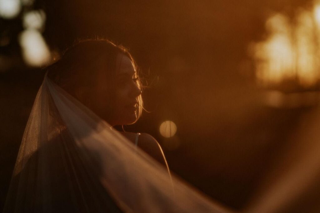 portrait of a bride standing in a beautiful golden light