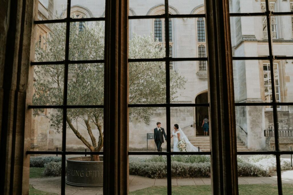 bride and groom walking on the college quad