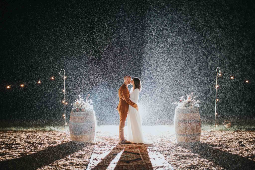 bride and groom kissing in the rain pennard hill farm