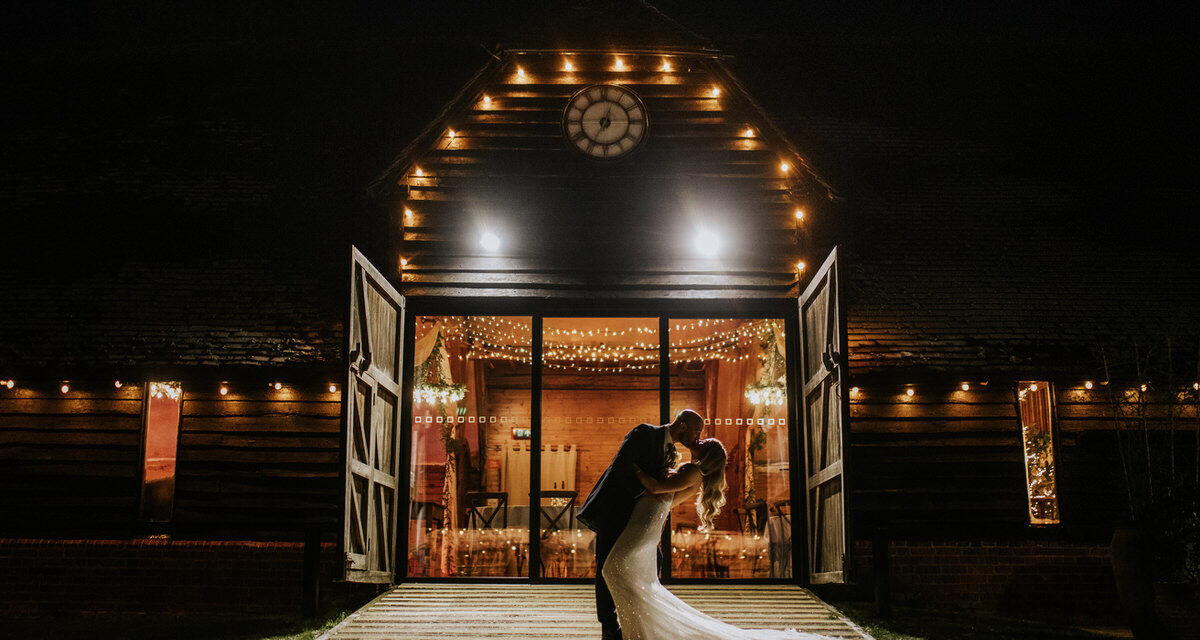 bride and groom kissing on the front of the lains barn