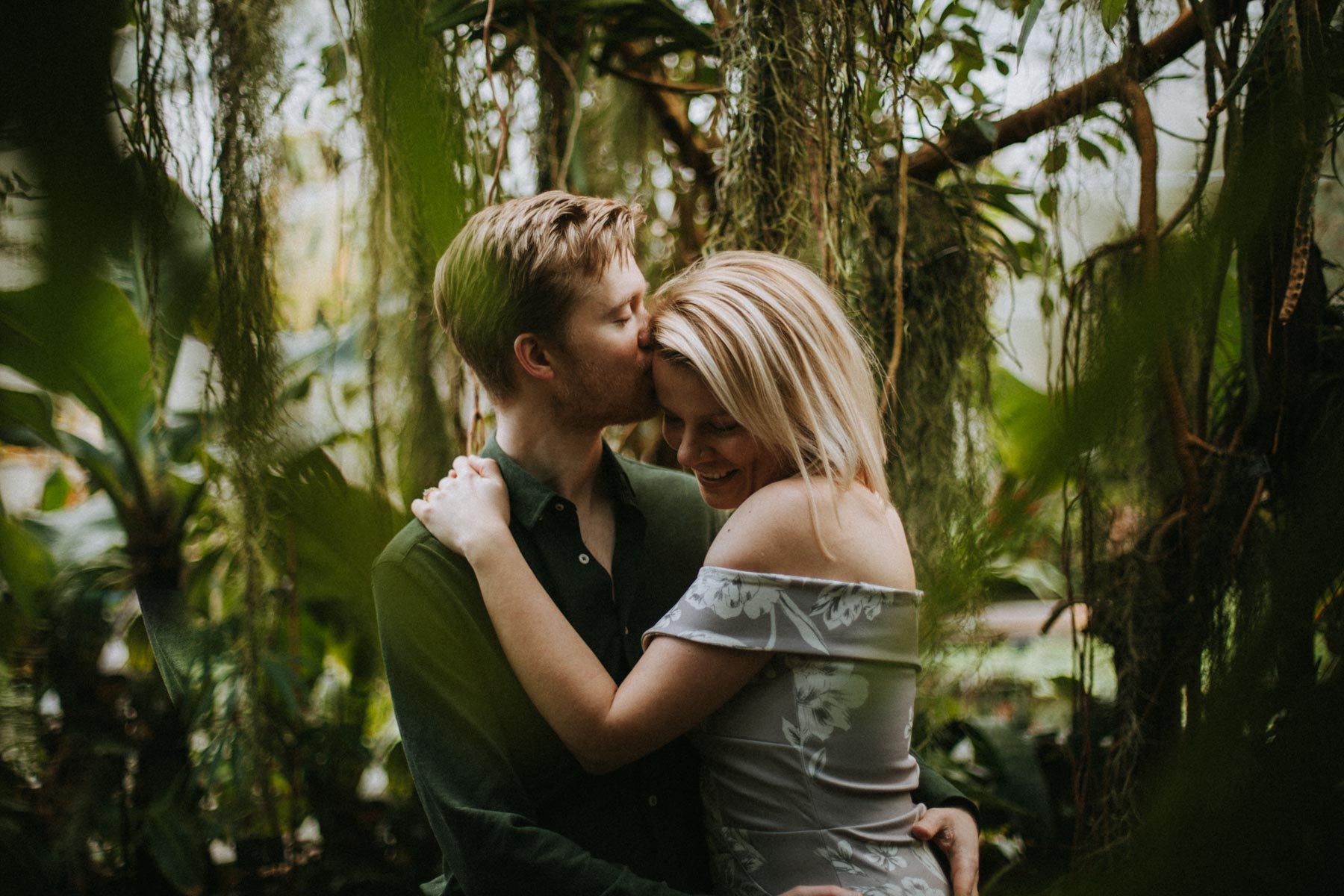 a couple kissing in the green house of oxford botanic garden